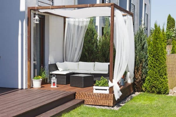 Chillout lounge on wooden terrace, How To Hang Outdoor Curtains Without Drilling Holes