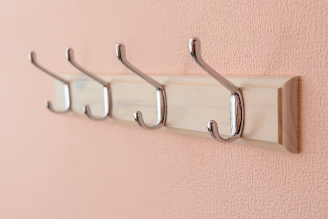 Clothes hangers on pink wall