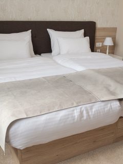 A comfortable hotel bedroom with split king bed, How to Fill the Gap in a Split King Bed [Step by Step Guide]