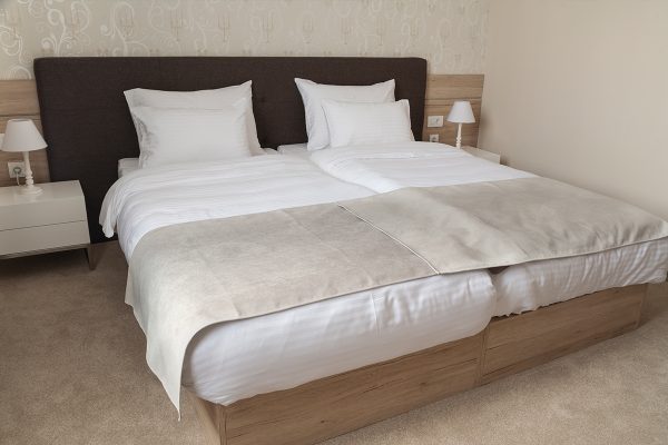 A comfortable hotel bedroom with split king bed, How to Fill the Gap in a Split King Bed [Step by Step Guide]