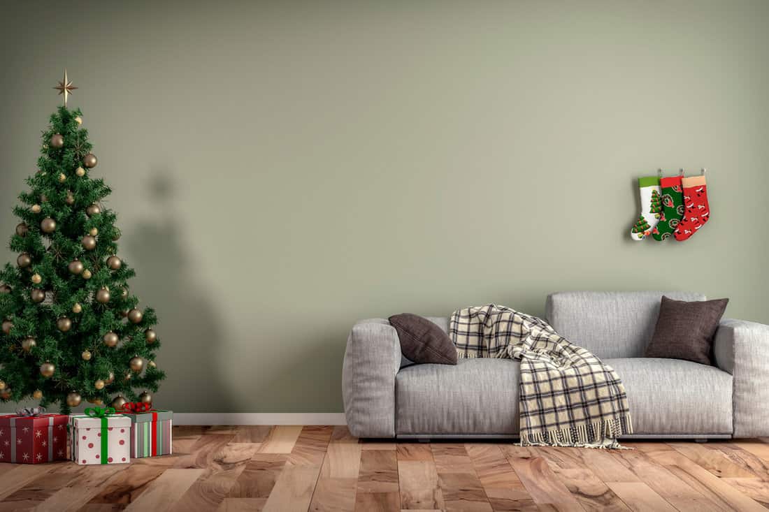 Empty simple living room with gray sofa, Christmas tree and gifts 
