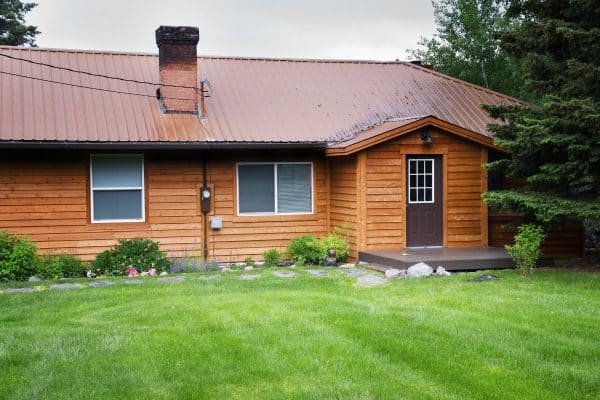 Front of rental cabin with cedar plank siding. - How Many Years Does Cedar Siding Last? [Pros, Cons, & Considerations For Homeowners]
