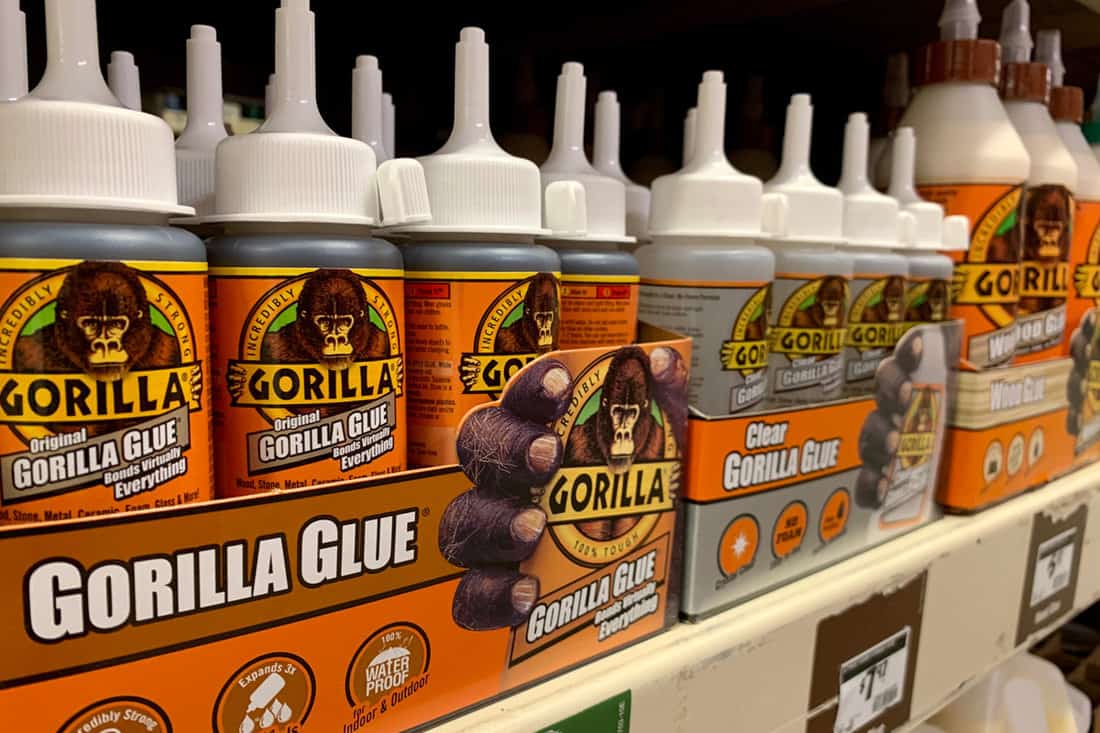 GORILLA GLUE product on shelf at home improvement retail store aisle.