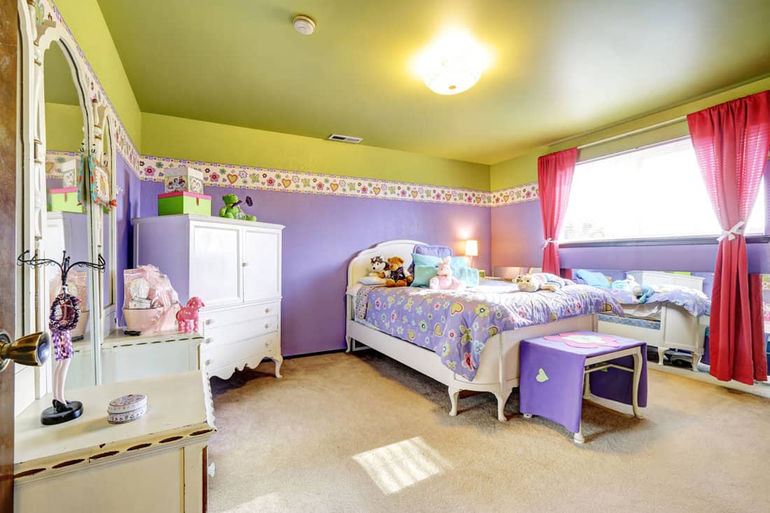 Girls children purple and green bedroom with mirror and white furniture