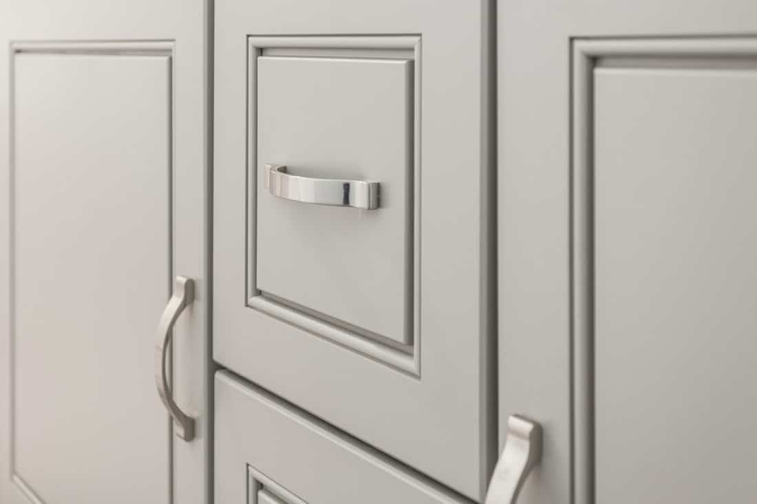 Grey / Gray cabinet, vanity with brushed nickel handles for bathroom or kitchen, close-up