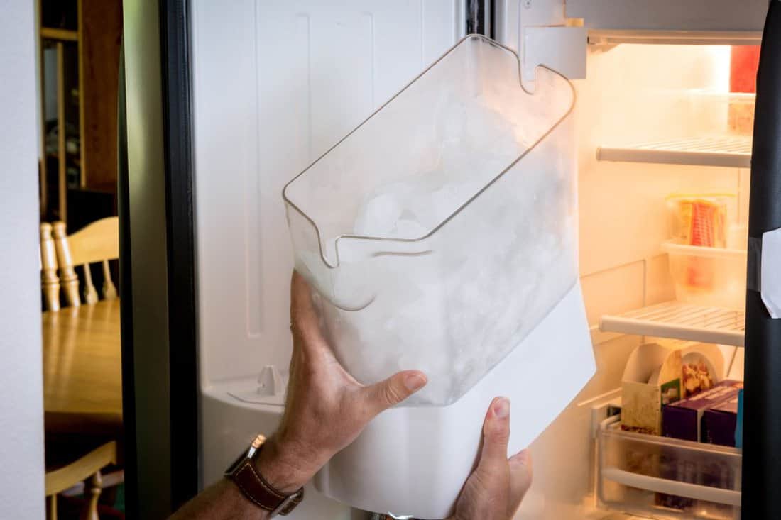 Ice maker remove shown with human hands