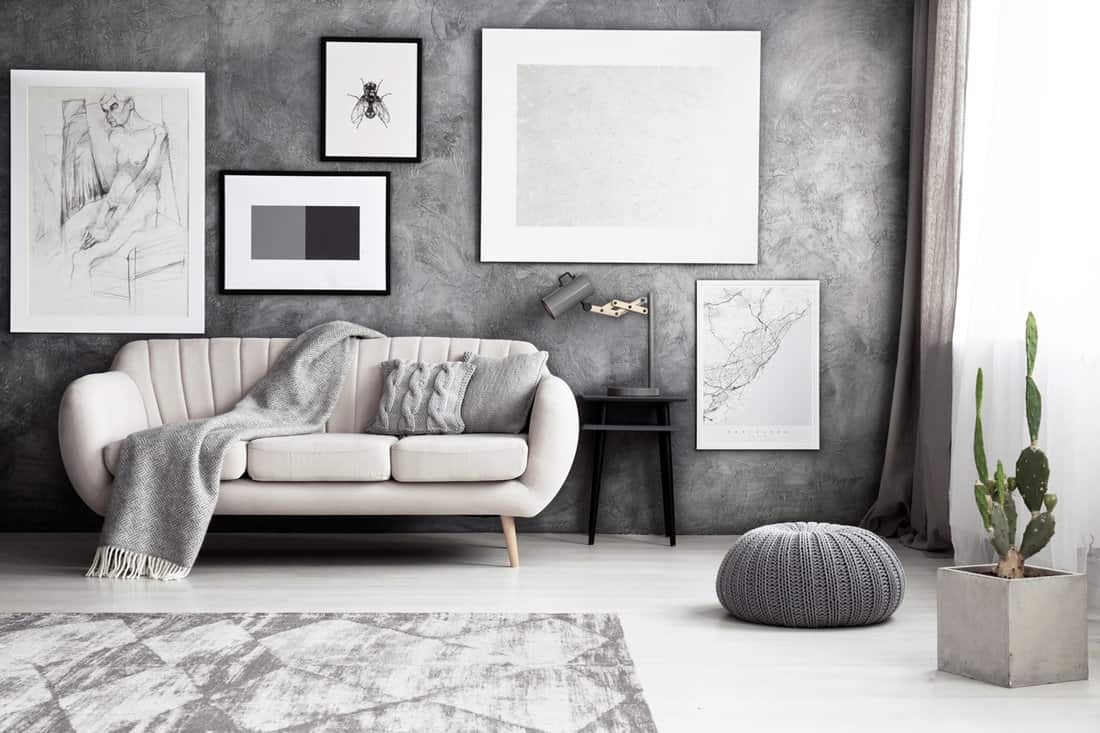 Interior of a gray inspired living room with white paint canvases
