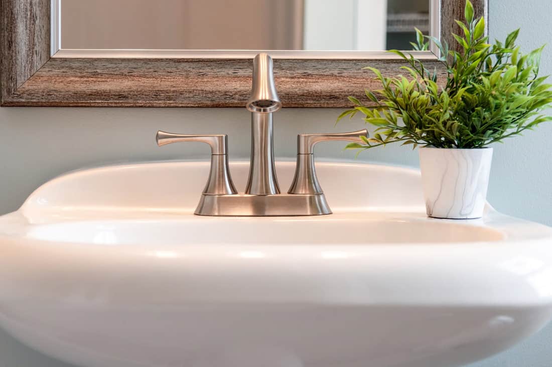 Light and bright closeup of bathroom sink with brushed nickel faucet home, decor, room, interior design, detail, style, clean, modern, minimal, copy space