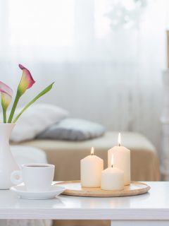Lit candles on a small plates at a spa, Can You Paint Candles? [And How To?]