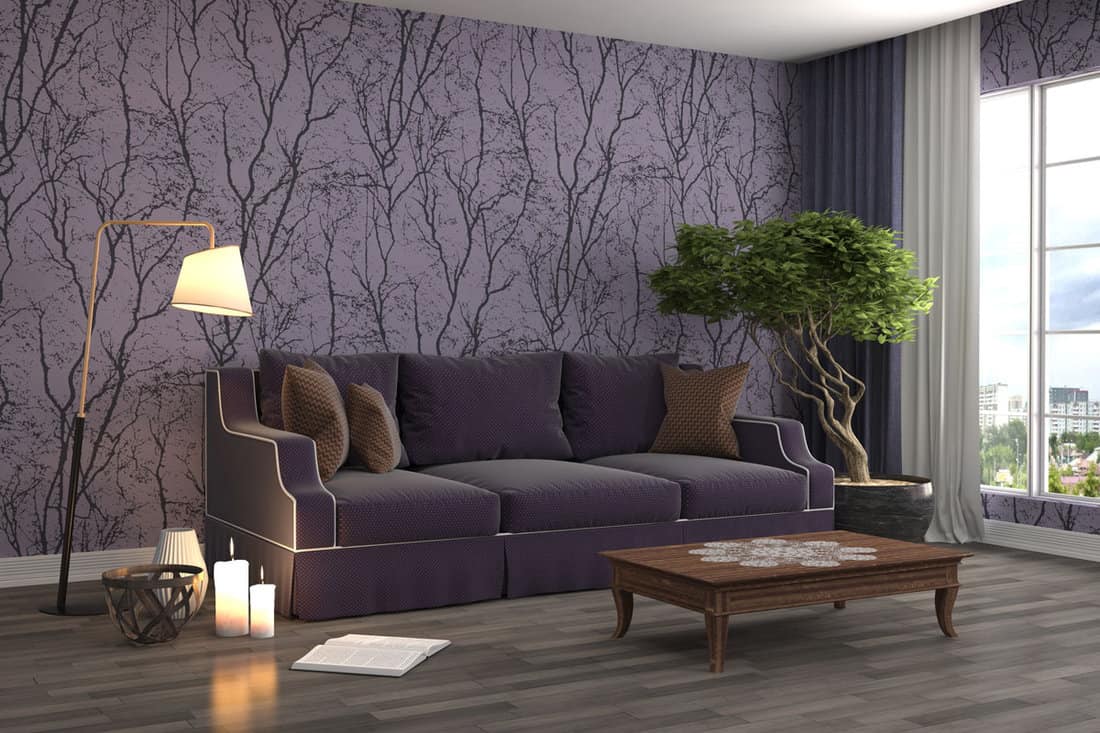 Living room modern design with branches design on a wall with a sofa and a bonsai tree beside it