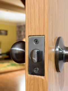 A living room through the open door, How To Open Locked Door With A Hole In The Knob?