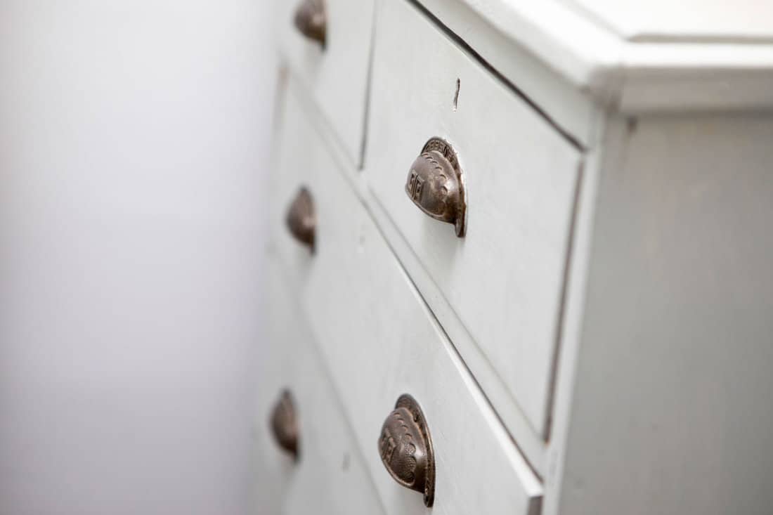 Old wooden chest of drawers with metal handles