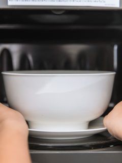 People putting food ceramic bowl in to the Microwave for reheating food., How To Tell If A Bowl Is Oven Safe [Inc. Ceramic, Metal, And More]