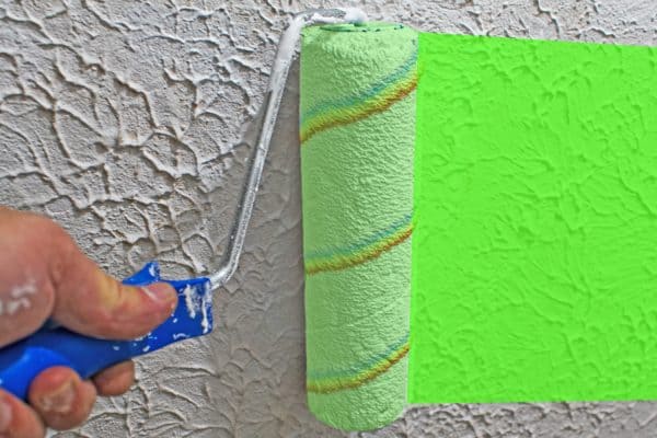 Renovation of the apartment. Painting a white wall in bright green. Rolling paint - How To Paint Latex Over Oil-Based Primer [& Tips For Homeowners]