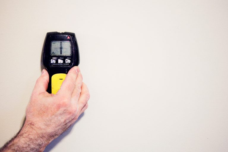 A photo of a stud finder attached to the wall, How To Use A Hart Stud Finder [Step By Step Guide]