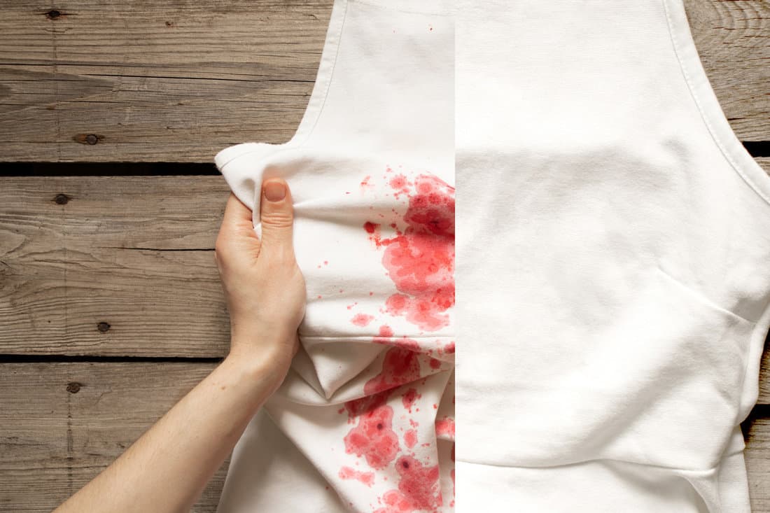 The girl holds in her hands a white dress with red spots and an example with a clean dress without a stain after washing, washing dirty clothes, dirty and clean clothes, before and after