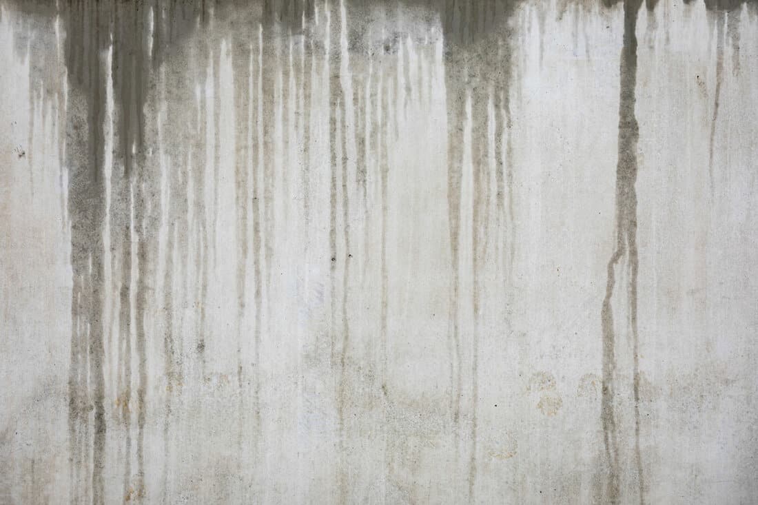 Wet concrete wall background at rainy day