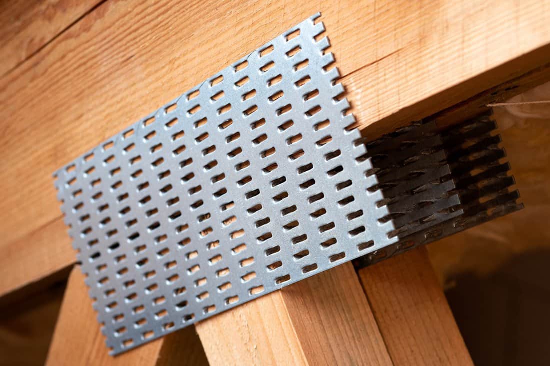 What is a truss plate - Detail of a truss with galvanized nail plates.