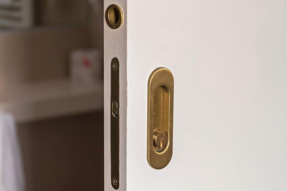White Panel Sliding Door With Brass Lockset