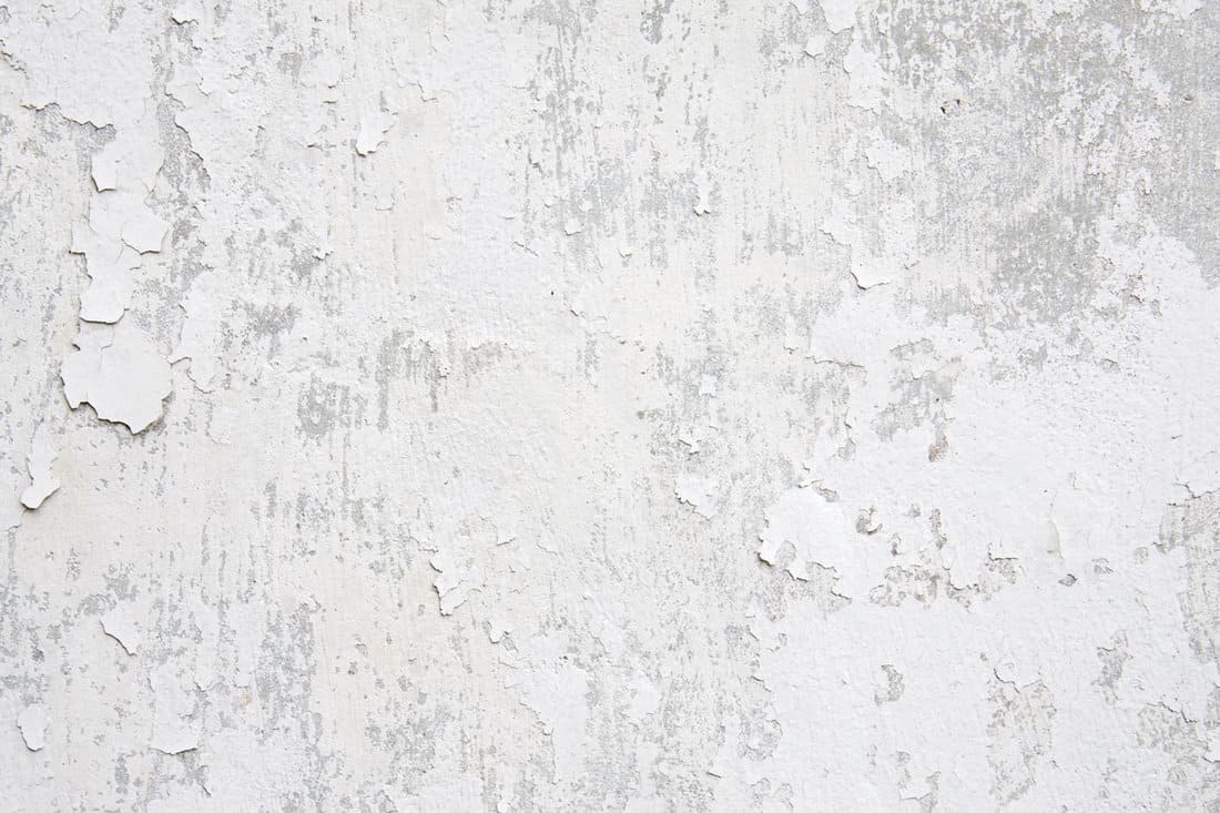 White weathered wall with flaking paint