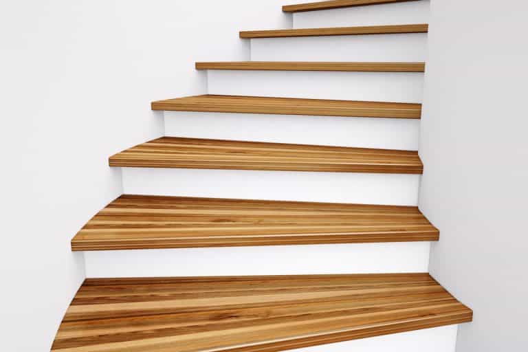 Wooden Stairs and white wall leading up