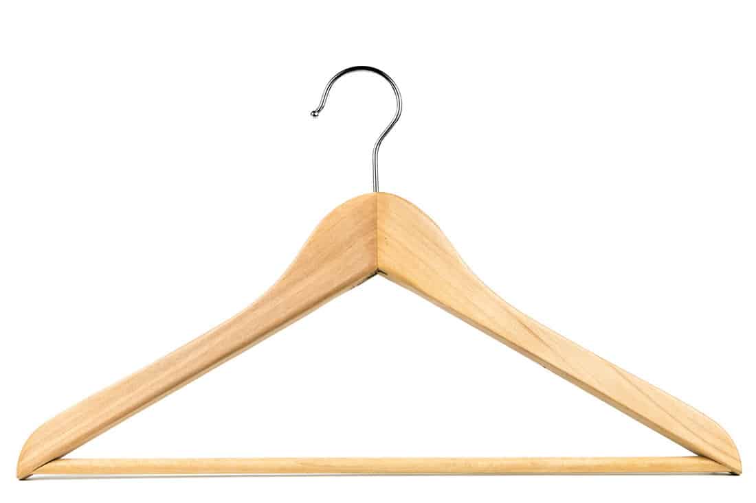 Wooden coat hangerclothes hanger on a white background. Potential copy space above and inside hanger.
