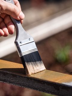 a man is painting a metal railing with copper varnish, How To Remove Paint From Copper