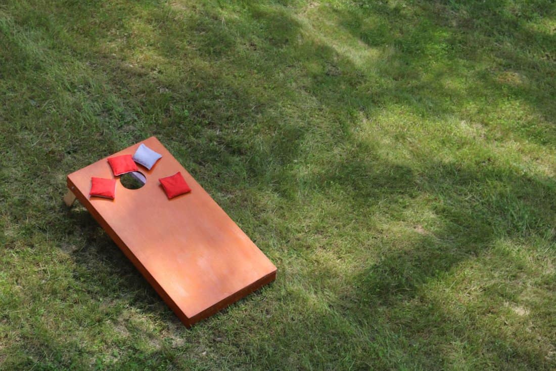 high angle view of Bean Bag Toss Corn Hole Game red bags and wood platform yard and park game