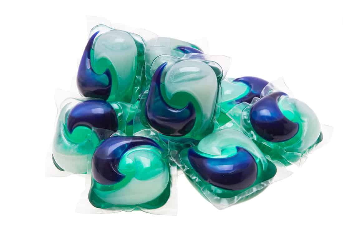 many washing capsule color green, white and blue on a plain white back ground
