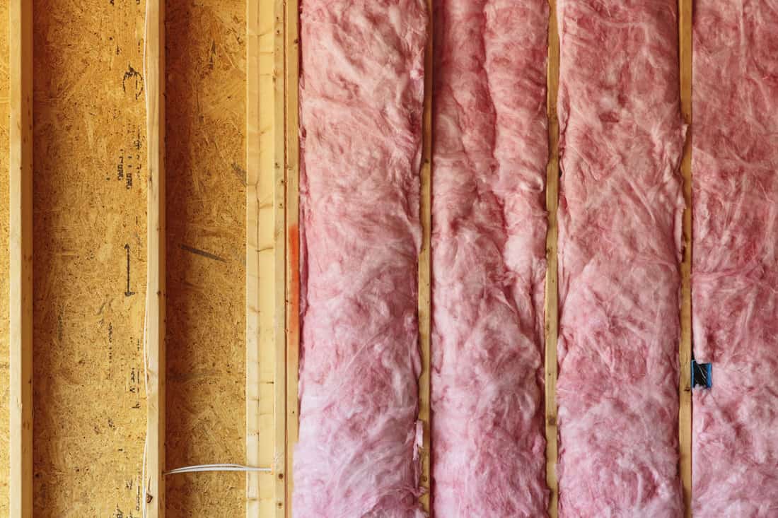 photo of a pink-insulation inside the walls of the room