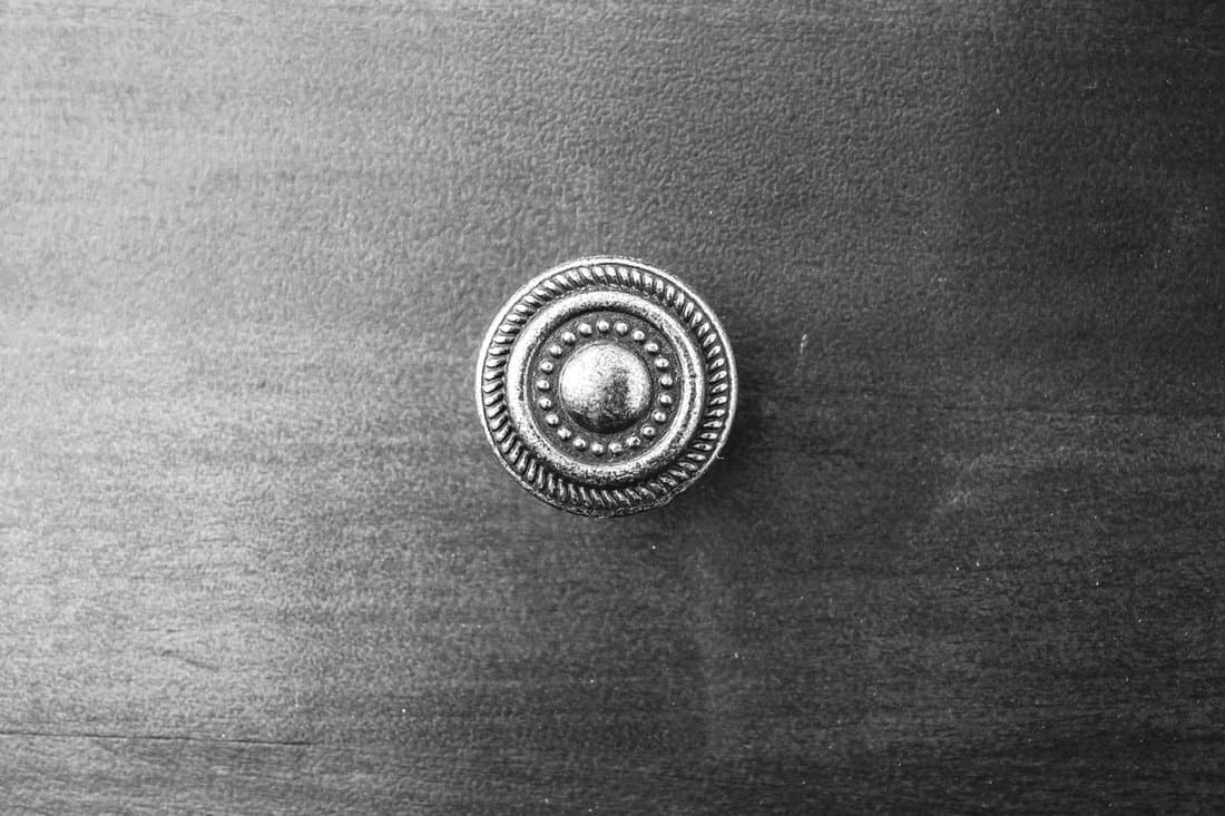 small circle handle on wood drawer with black and white vintage filter