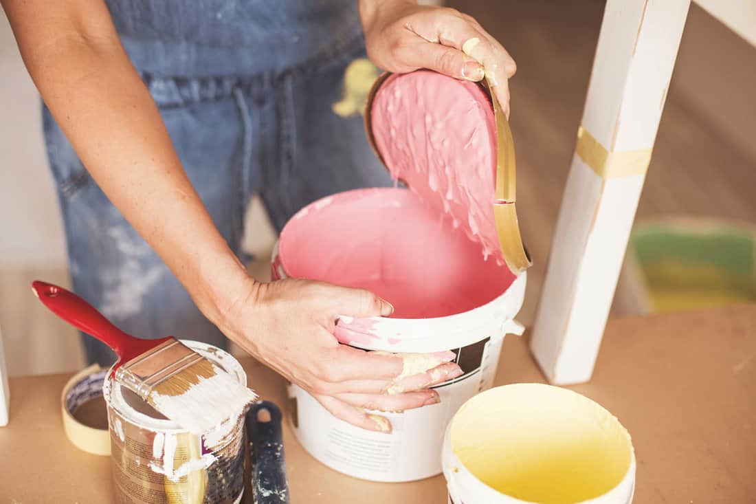 woman opening the old pink paint reusable