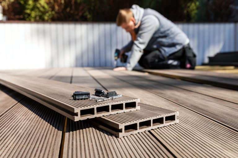 wpc terrace construction - worker installing wood plastic composite decking boards - How Hot Does a Wood Deck Get