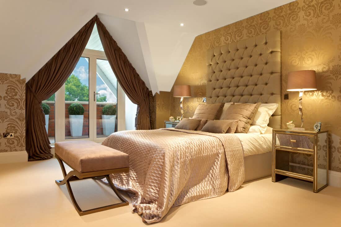 a beautiful bedroom in a luxury penthouse apartment of an expensive new development. Tastefully decorated and furnished by a leading interior designer. This image could also feature a luxury hotel room.