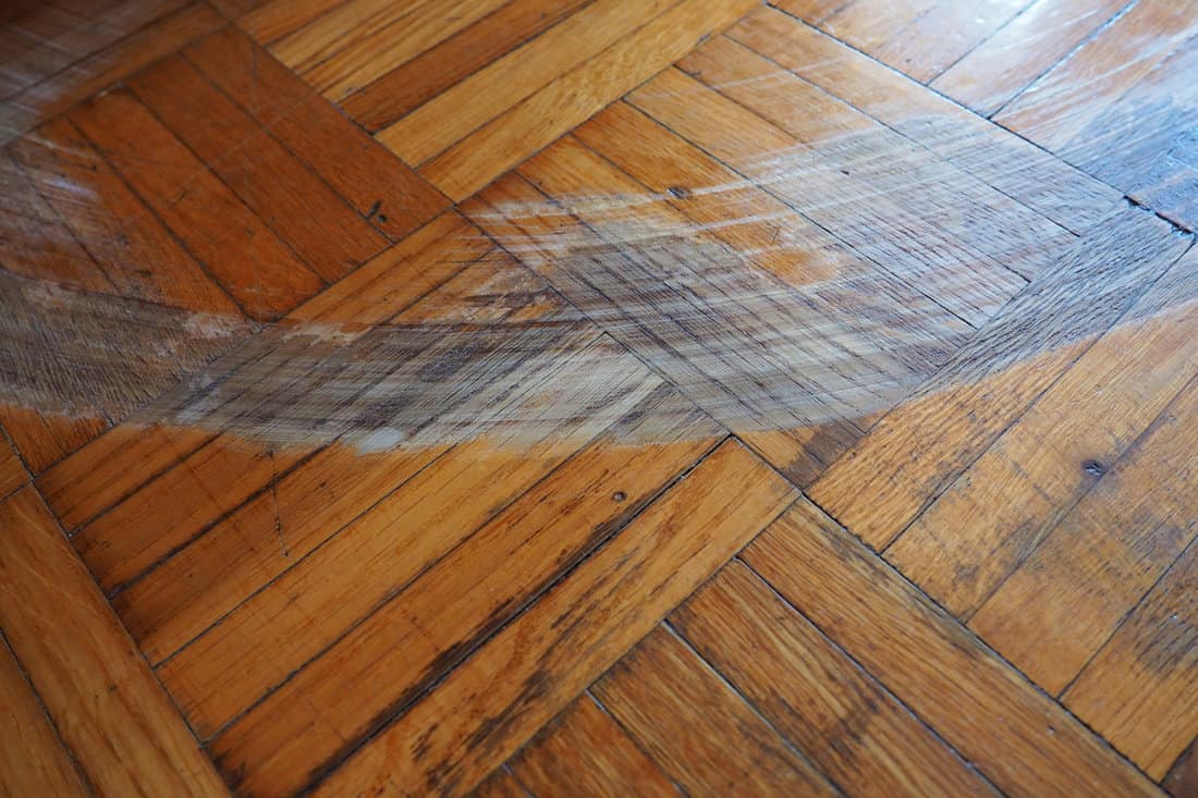 A huge scratch on the parquet flooring