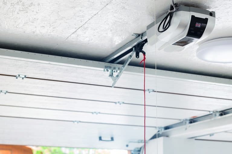 Automatic garage door opener electric engine gear mounted on ceiling with emergency cord, How To Program (& Reset) My Garage Door Opener With Dip Switches
