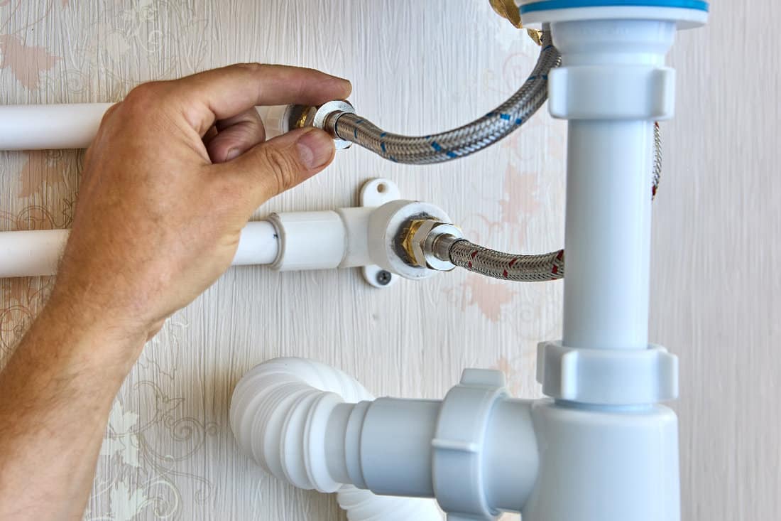 Braided plumbing hoses are used to install faucet in bathroom