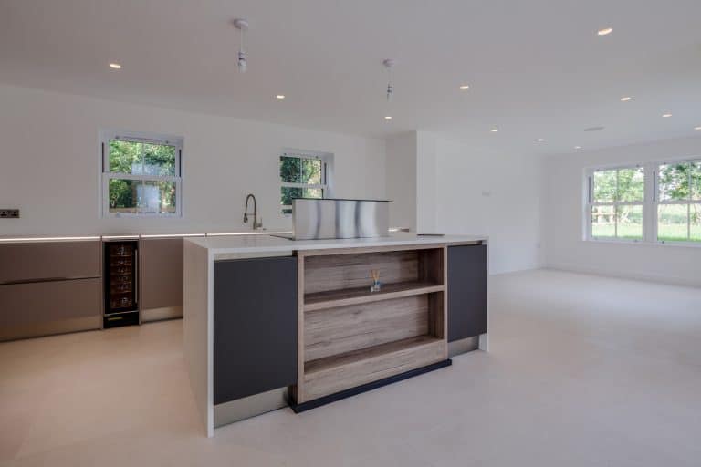 Brand new luxury kitchen with built in appliances and cupboards including wine fridge and peninsular unit housing hob - Avonite Vs Corian: Which Countertop Material To Choose