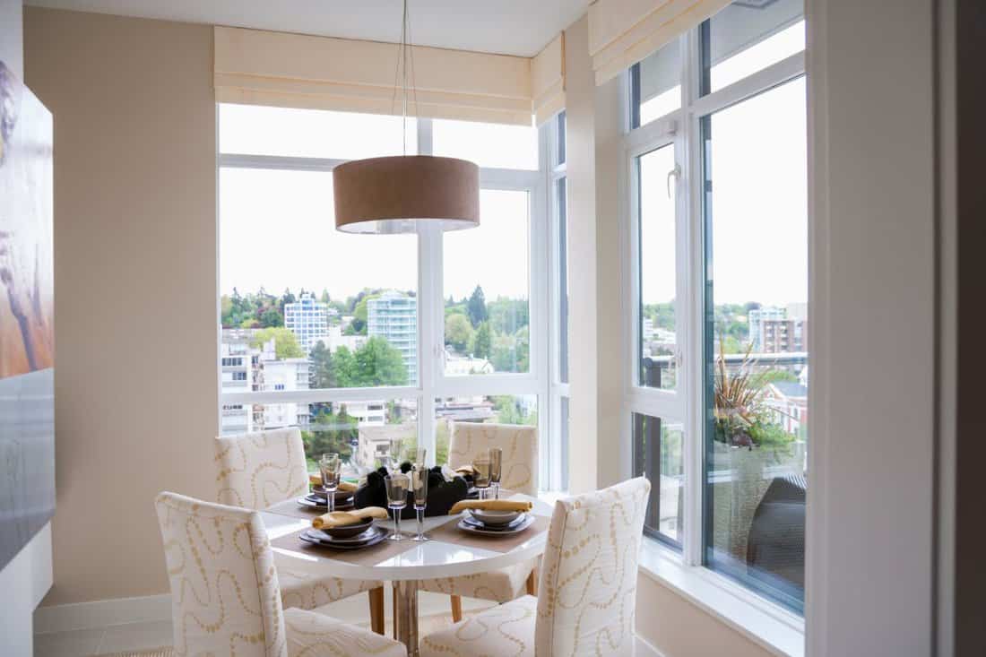 Breakfast nook surrounded by picture windows in condo