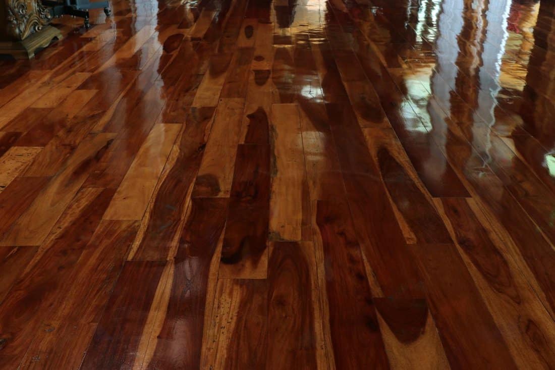 Brown hardwood floors with a shiny lacquered finish.