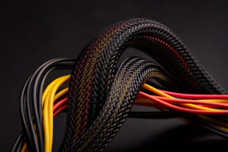 Cable snake skin. Black braided wires in bundle on black background., Braided Vs Non Braided Cable: Pros, Cons, & Differences