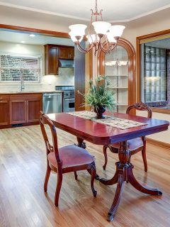 A dining room with vintage table set, built in cabinets and light hardwood floor, What Color Trim Is Best With Alabaster Walls? [15 Light & Dark Colors To Choose From!]