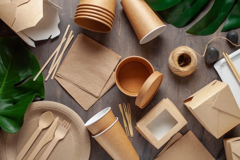 Eco craft paper tableware. Paper cups, dishes, bag, fast food containers and wooden cutlery on wooden background. Recycling or eco-friendly concept, Can You Microwave Paper Cups & Plates Safely? For How Long?