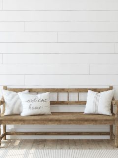 Farmhouse entryway. Wooden bench near white shiplap wall. Interior mockup. - How To Fill Shiplap Gaps & How To Fill Nail Holes In Shiplap [For An Expert Look!]