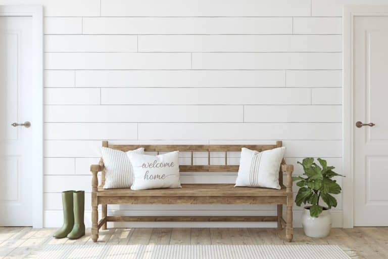 Farmhouse entryway. Wooden bench near white shiplap wall. Interior mockup. - How To Fill Shiplap Gaps & How To Fill Nail Holes In Shiplap [For An Expert Look!]
