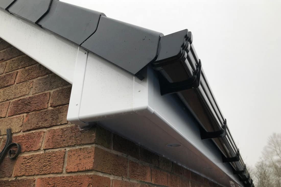 Fascia board and roofing and guttering system newly fitted with cap ends for protection of roof
