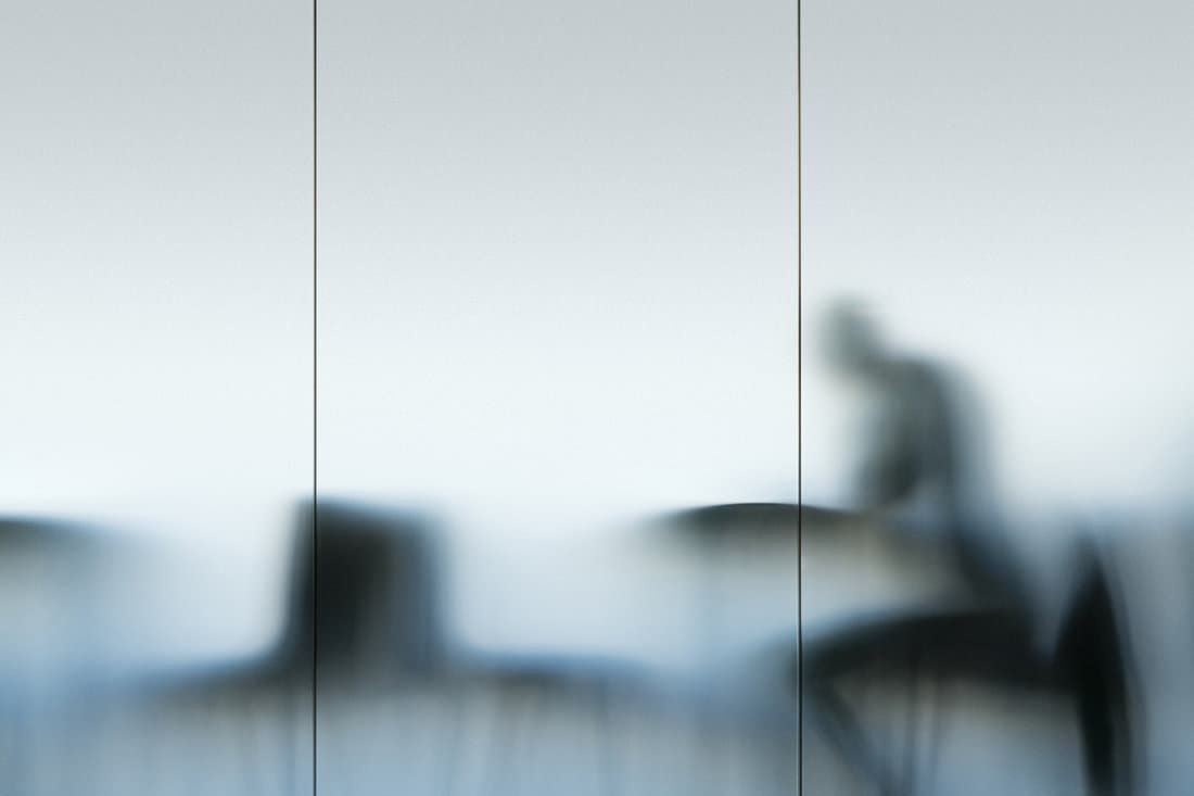 Figure behind opal glass panel