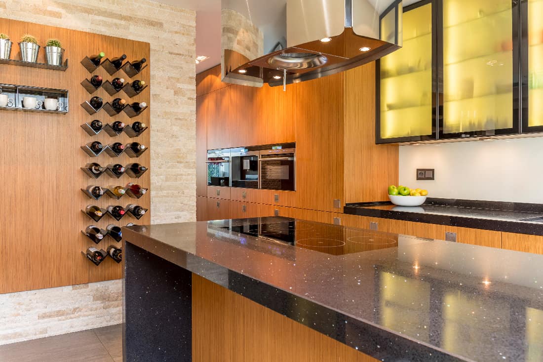 Glamourous kitchen with wooden cabinets and wine racks