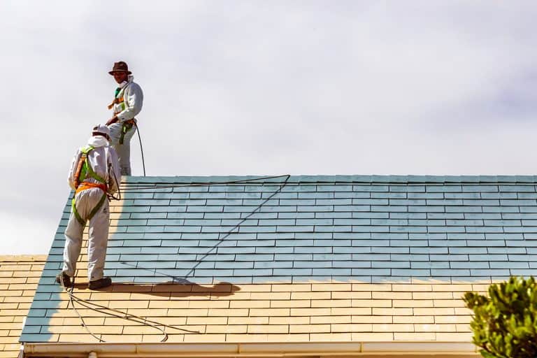 Men with protective clothing spray painting the roof, Can I Paint Roof Shingles?