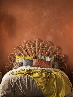 Orange boho style interior with armchair, dresser and decor, What Colors Go With A Rust Color Scheme In Your Home? [17 Color Ideas You Will Love!]